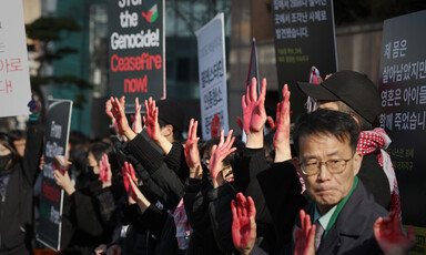 Protestors in Seoul hold up placards demanding an end to the genocide in Gaza