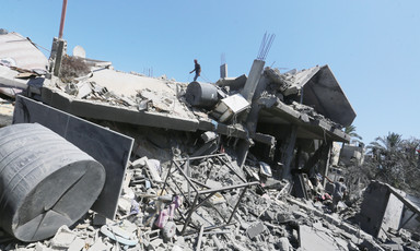 A man amid a large amount of rubble in central Gaza 