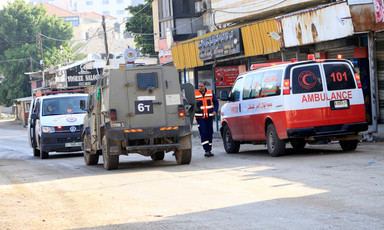 An Israeli military vehicle beside two ambulances in the occupied West Bank 