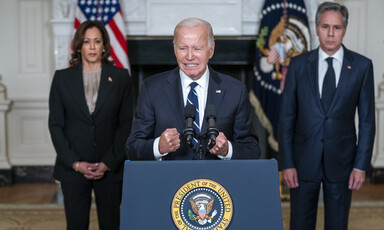 President Joe Biden speaks in the State Dining Room of the White House with Vice President Kamala Harris and Secretary of State Tony Blinken behind him