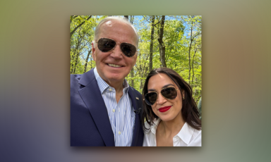 Man and woman pose together in sunglasses against a backdrop of trees