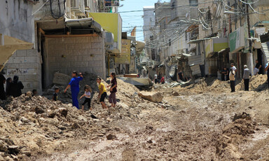 People inspect damaged road