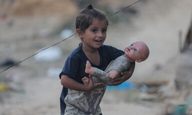 A child holds a doll 