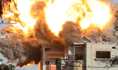 A fireball rises over a building