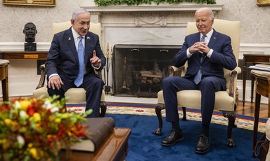 Netanyahu and Biden sit next to each other in chairs