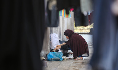 A woman washes clothes by hand