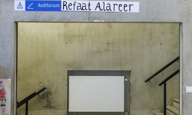 A sign reading Auditorium Refaat Alareer 