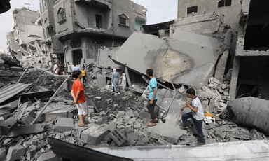 People inspect damage to homes in Gaza