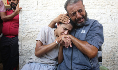 Man and boy cry as they embrace on another 