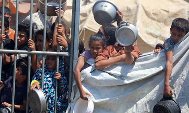 Children with empty pots await food aid