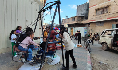 Children play on a swing