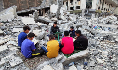 children read amid rubble