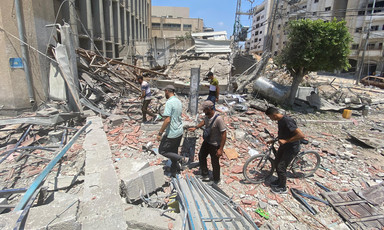 people look through rubble after an Israeli airstrike