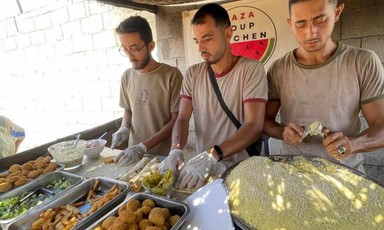 Three men make falafel