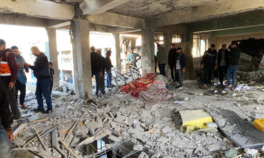 A number of people gather in a Gaza school after Israel carried out a massacre there 