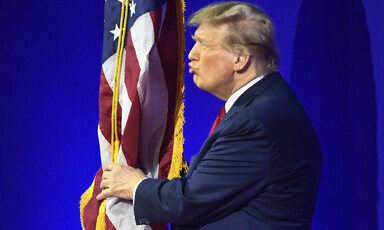 Donald Trump embraces and air kisses the American flag