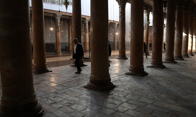 One person walks down the middle of an empty church