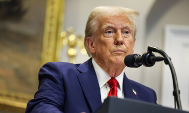 President Donald Trump behind a podium and microphone