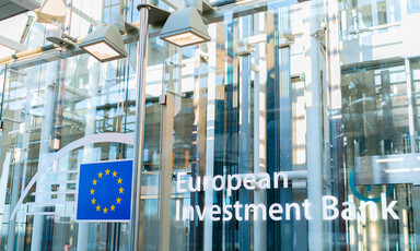 A facade with a blue and yellow logo and the words European Investment Bank 