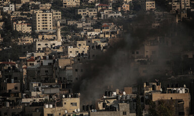 Smoke rises amid a dense residential area 