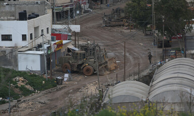 Armored vehicle on a road in a village 