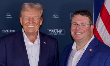 President Donald Trump stands next to Randy Fine, a state senator from Florida