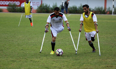 Footballers on crutches at play