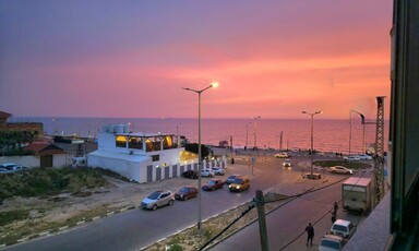 A building beside a road in a sunset 