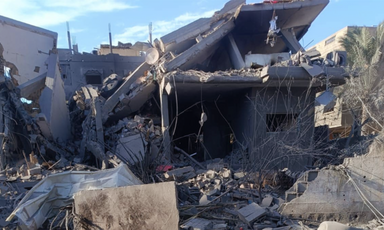 A home now collapsed on itself, the second floor roof falling. 