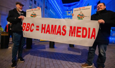 Protestors hold up a banner equating the BBC with Hamas