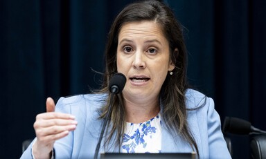 Congresswoman Elise Stefanik at microphone emphasizes a point with her hand