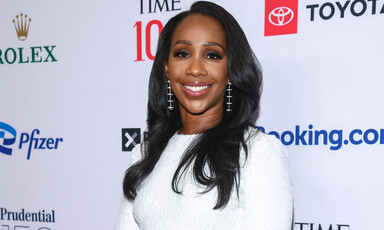 CNN anchor Abby Phillip at TIME 100 Gala with names of the event’s associated corporate partners behind her