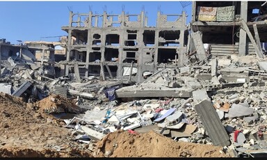 Rubble beside the shell of a building that Israel has attacked in Gaza