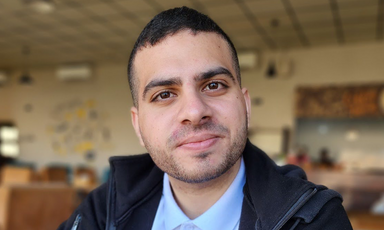 A man smiles at the camera