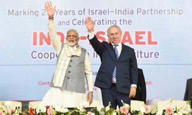 Indian Prime Minister Narendra Modi and Israeli Prime Minister Benjamin Netanyahu wave to an unseen audience