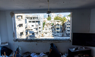 A view of devasted buildings, looking out through a window 