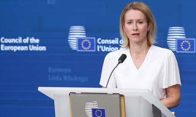 The European Union's foreign policy chief Kaja Kallas stands at a lectern with a microphone