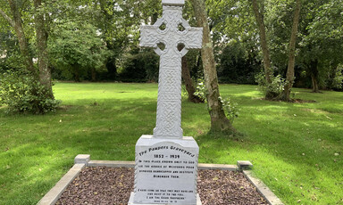 A Celtic cross surrounded by trees 