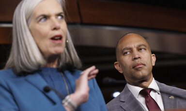 Congresswoman Katherine Clark speaks from a podium as Congressman Hakeem Jeffries looks on