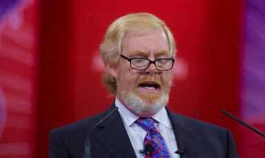 L. Brent Bozell III speaking into microphones