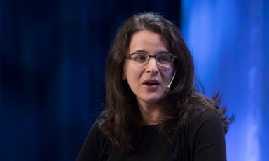 Sarah Hurwitz speaks into a microphone headset