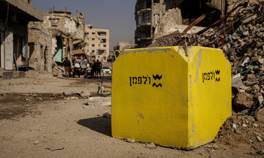 Large yello concrete block seen among ruins