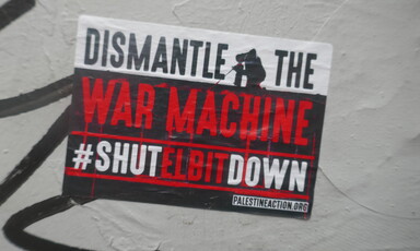 A poster reading Dismantle the War Machine Shut Elbit Down 