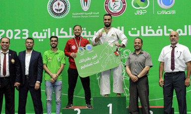People pose with their medals on a podium