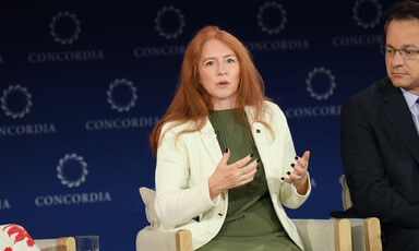 A woman gestures on stage