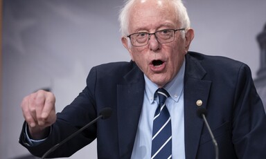 Senator Bernie Sanders gesticulates behind a podium