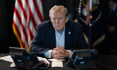 Trump at desk with telephones in front of him