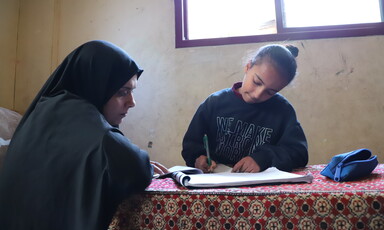 A girl writes in a notebook