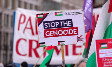 A placard reading Stop the Genocide 