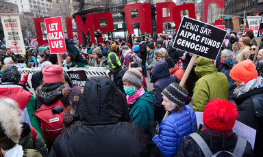 Protesters carry signs criticizing the Gaza genocide and AIPAC
